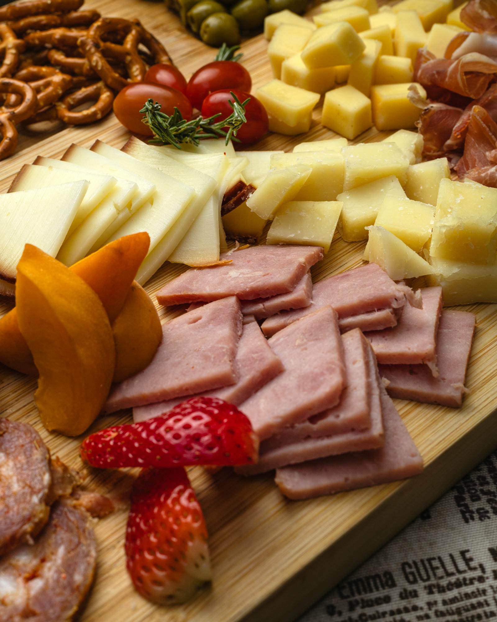 Close-up of artisan cheeses and folded cured meats